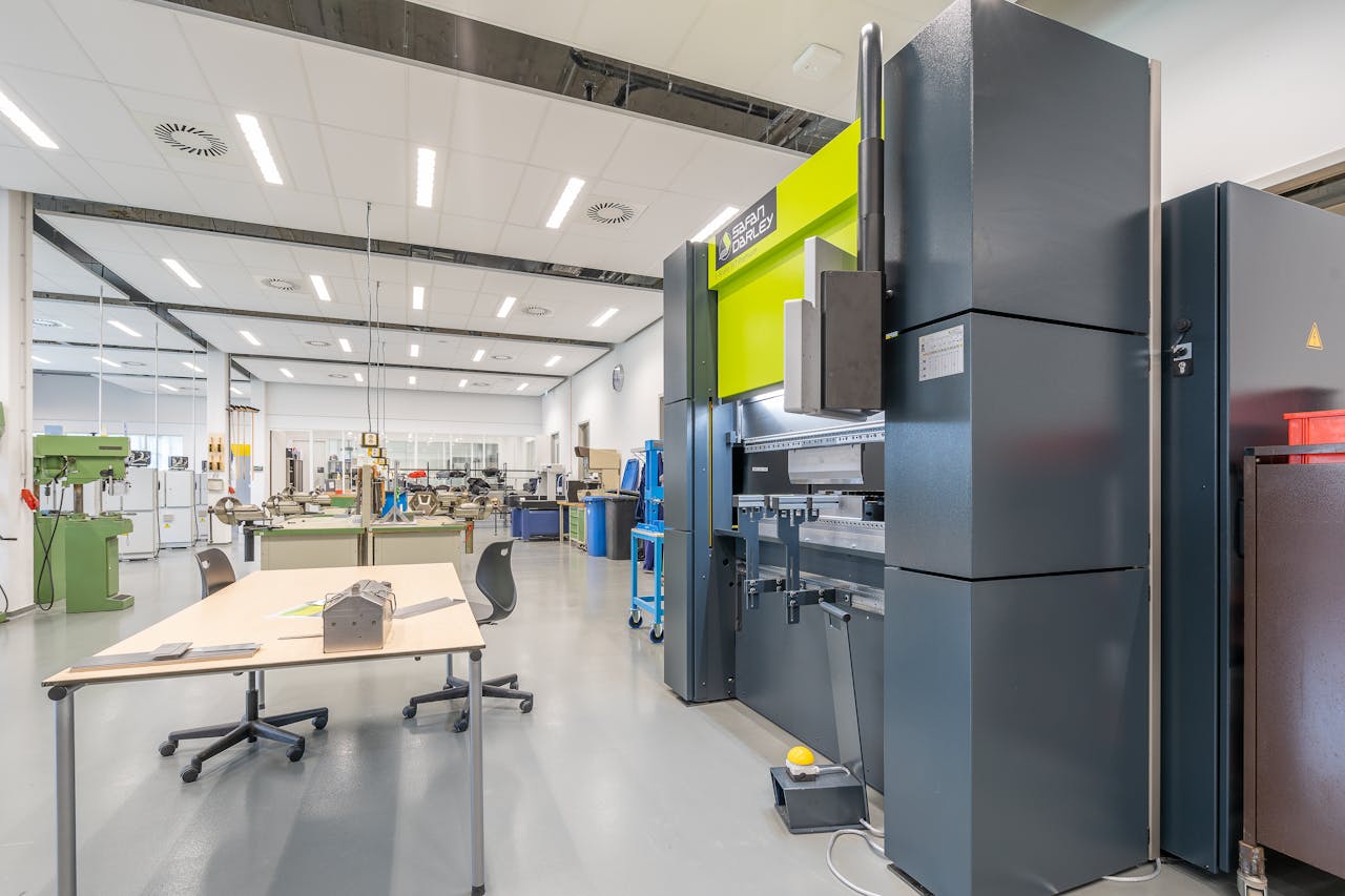Spacious industrial workshop featuring advanced machinery and organized workstations.